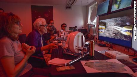 Stanford University roboticist Oussama Khatib (second from left) was able to feel sensations in his hands using the robot's feedback system.