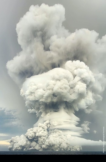 Eruption of the Hunga Tonga Hunga Ha'apai.  A gigantic cloud of ash and smoke shoots straight up into the...