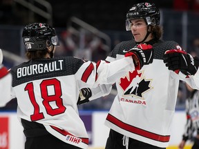 Xavier Bourgault (18) and Owen Power (25) of Canada celebrate a goal against Czech Republic during the 2022 IIHF World Junior Championship at Rogers Place on Sunday December 26, 2021.