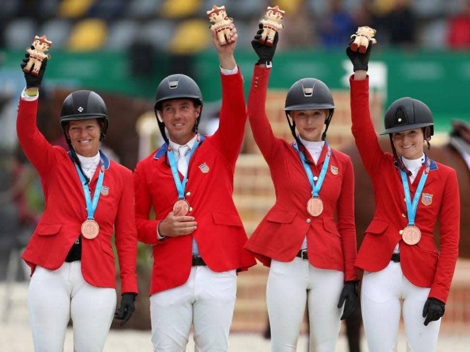 The US team (left to right) Elizabeth Madden, Alex Granato, Eve Jobs, daughter of the late Apple Inc. co-founder and CEO Steve Jobs, and Lucy Deslauriers celebrate their bronze medal in the Equestrian Jumping Team Round 2 competition during the Pan American Games 2019 in Lima on August 7, 2019.