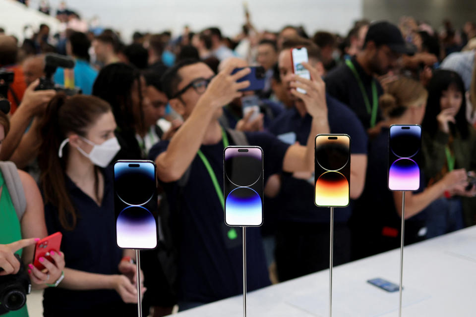 A guest looks at the new iPhone 14 at an Apple event at their headquarters in Cupertino, California, on September 7, 2022.  REUTERS/Carlos Barria