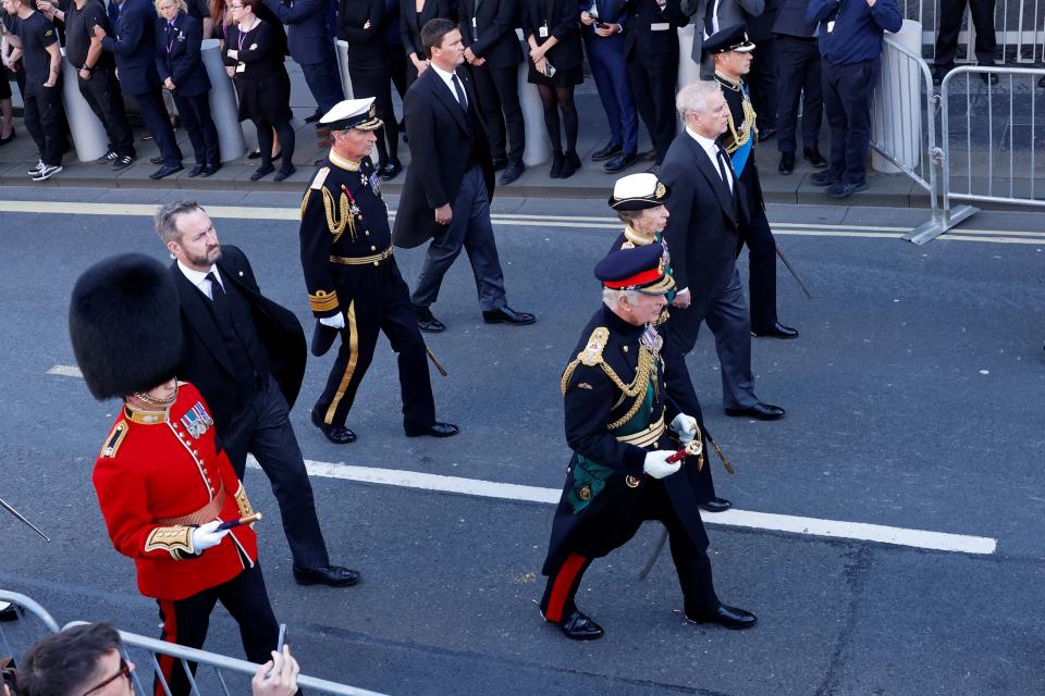 Britain's King Charles III (4R), Britain's Princess Anne, Princess Royal (3R), Britain's Prince Andrew, Duke of York (2R) and Britain's Prince Edward, Earl of Wessex (R) walk behind the procession of the coffin of Queen Elizabeth II from the Palace of Holyroodhouse to St Giles Cathedral on the Royal Mile on September 12, 2022 where Queen Elizabeth II will rest.  - Mourners will get their first opportunity to pay their respects to Queen Elizabeth II's coffin on Monday, as it lies in an Edinburgh cathedral where King Charles III.  will lead a vigil.  (Photo by Odd ANDERSEN/POOL/AFP) (Photo by ODD ANDERSEN/POOL/AFP via Getty Images)