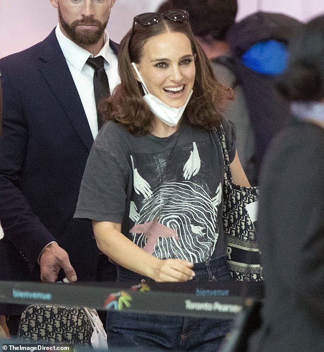 Fashionable: The actress donned blue jeans and a printed shirt to stay comfortable on her travels