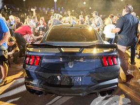 Crowds surround the new Ford Mustang Dark Horse after its debut at the North American International Auto Show in Detroit, Michigan on September 14, 2022.