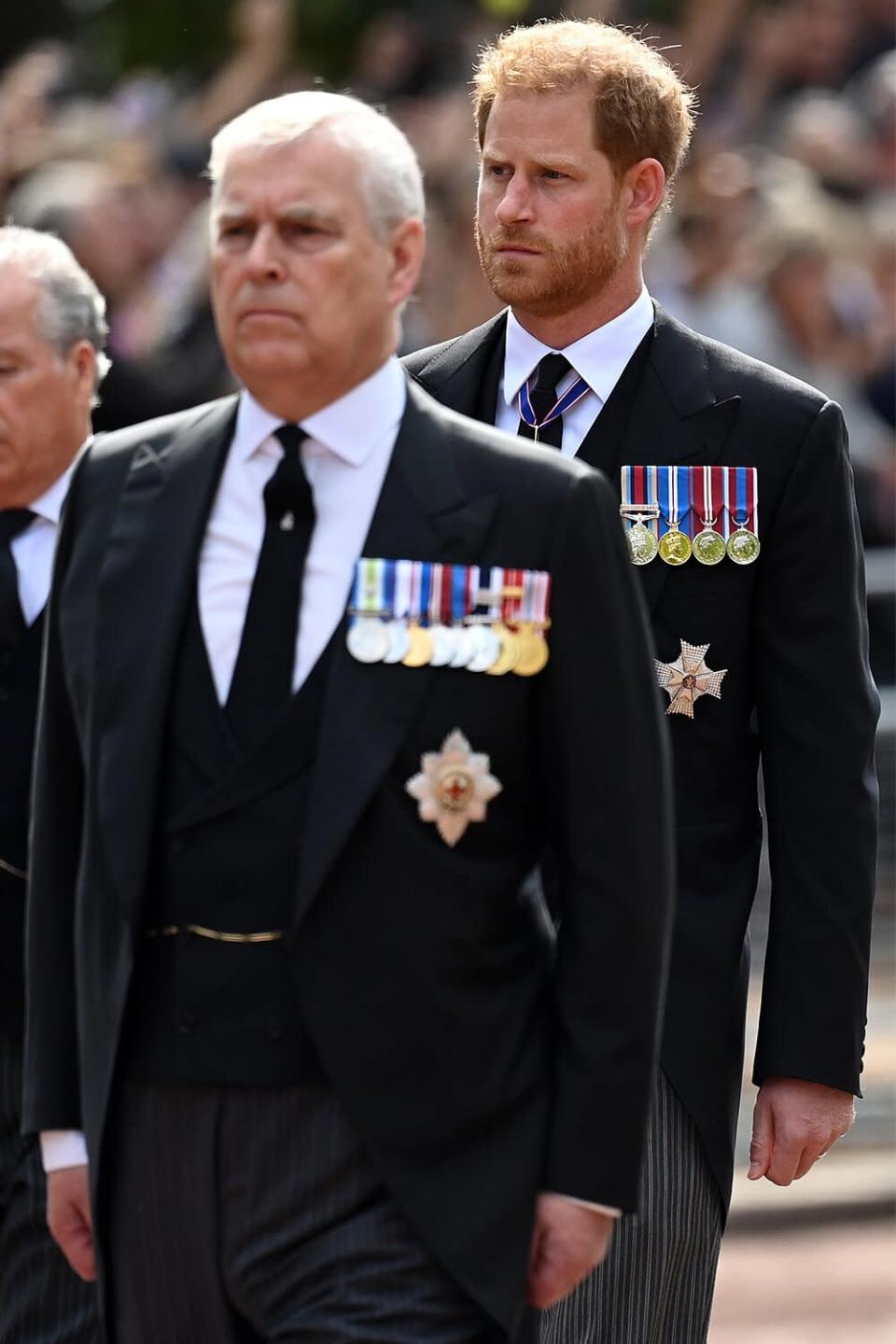 Prince Andrew, Duke of York and Prince Harry, Duke of Sussex walk behind the coffin during the procession for the Reclining State of Queen Elizabeth II on September 14, 2022 in London, England.  The coffin of Queen Elizabeth II is carried in a procession on a carriage of the King's Troop Royal Horse Artillery from Buckingham Palace to Westminster Hall, where her burial will last until the early morning of her funeral.  Queen Elizabeth II died at Balmoral Castle in Scotland on 8 September 2022 and is succeeded by her eldest son, King Charles III.