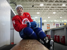 Rookie Canucks winger Andrey Kuzmenko smiles on the bench during the first day of Canucks training camp in Whistler Thursday.