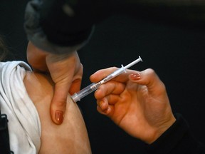 FILE PHOTO: Sister Rachelle Lively dispensed COVID immunizations as part of the City of Calgary's mobile immunization program expansion, a short-term COVID-19 immunization station that opened Monday, January 3, 2022 at the Southcentre Mall.