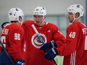 New Vancouver Canuck Ilya Mikheyev (center) talks to his new Russian linemate Andrey Kuzmenko while Elias Pettersson (right) waits to speak during the first day of Vancouver Canucks training camp in Whistler September 22, 2022.