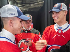 Juraj Slafkovsky of Slovakia, right, greets compatriot and Canadian draft pick Filip Mesar, left, while Simon Nemec, also of Slovakia and selected by the New Jersey Devils, looks on during the first round of the 2022 NHL Draft July 7 in Montreal .  2022.