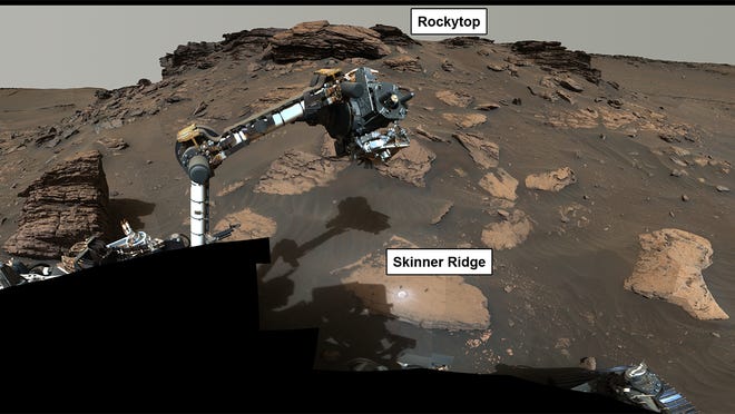 NASA's Perseverance rover wraps its robotic arm around a rocky outcrop called