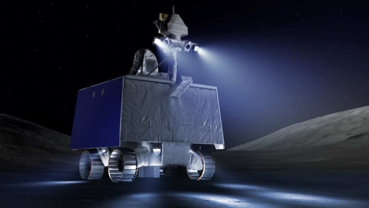 A graphic showing NASA's VIPER rover cruising on the moon using searchlights attached to a tower that rises from its boxy shape