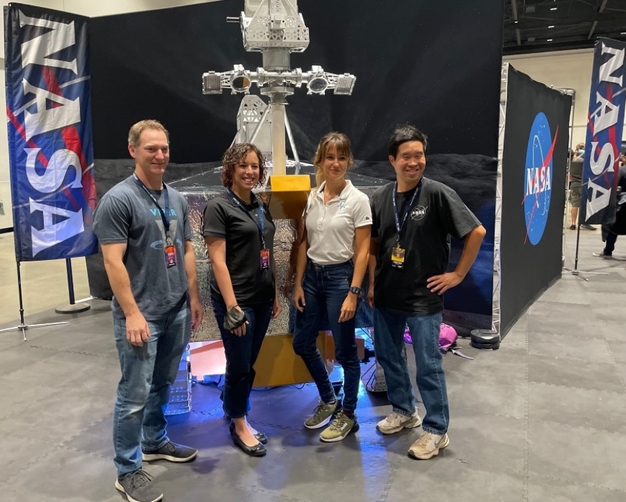 Four NASA employees are at SiliCon with the VIPER rover model