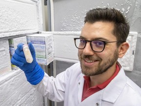 John Chmiel, a PhD student in Microbiology and Immunology at Western University, holds up a sample of faeces stored at -80C at St Joseph's Hospital in London on Wednesday September 14, 2022.  St. Joseph's Health Care is in need of healthy adults willing to donate feces for the beneficial gut microbes harvested to treat stubborn, potentially deadly gut infections.  (Mike Hensen/The London Free Press)