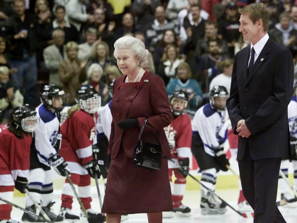 Why did Queen Elizabeth II drop the puck at a Canucks game?