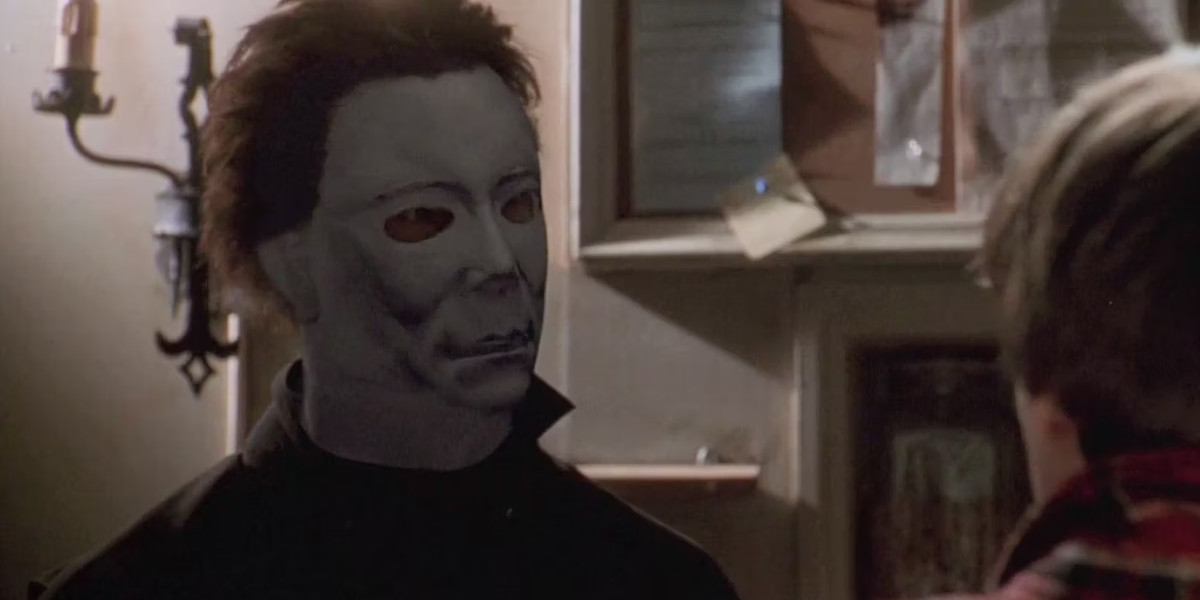 Michael Myers on H20 looks at a frightened person with much larger eye holes in the mask.