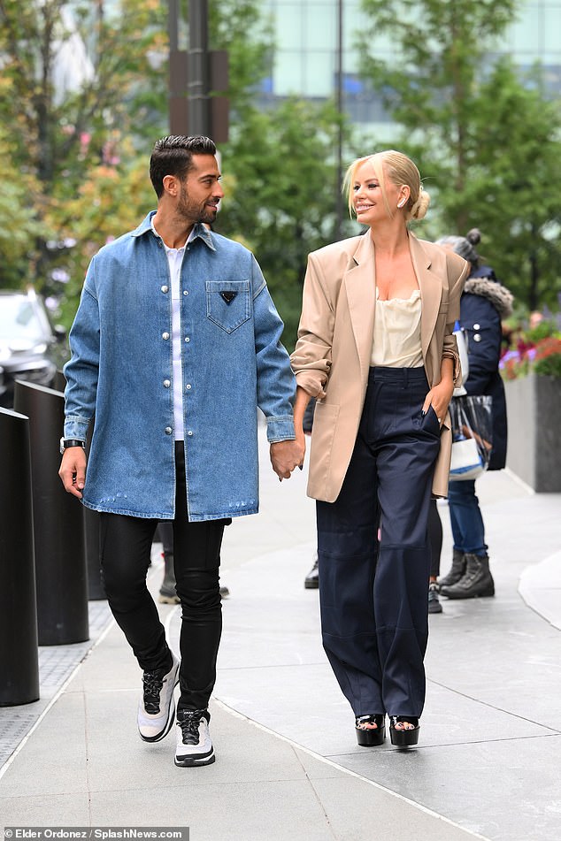 Chic: The reality TV star wore an oversized broad-shouldered tan blazer over a cream silk cami, which she paired with wide-leg navy pants and black platform heels