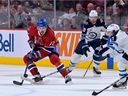 Montreal Canadiens defenseman Arber Xhekaj moves the puck against Winnipeg Jets forward Brad Lambert during the first half at the Bell Center in Montreal on September 29, 2022. 