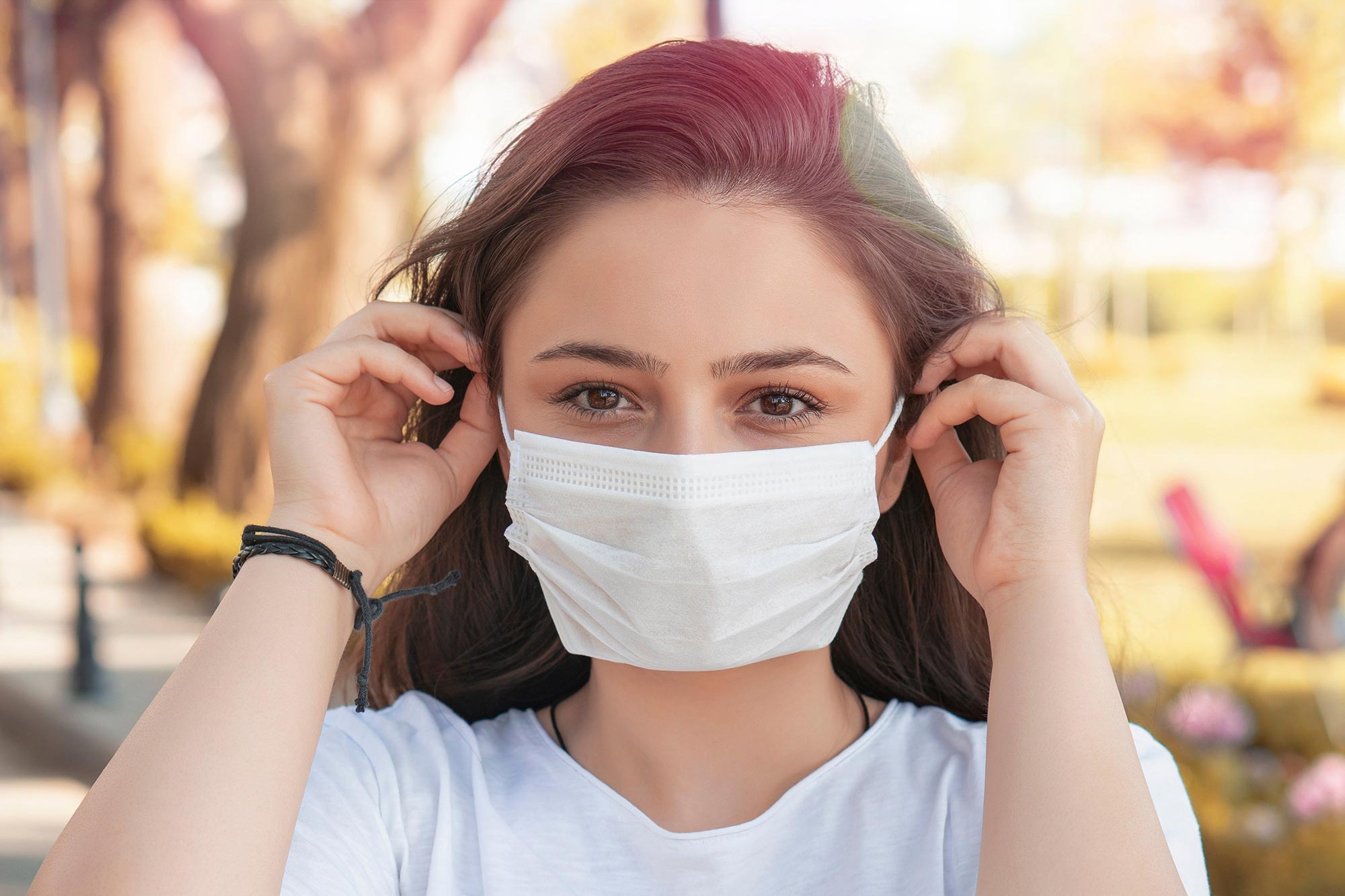 Woman Putting on COVID Face Mask