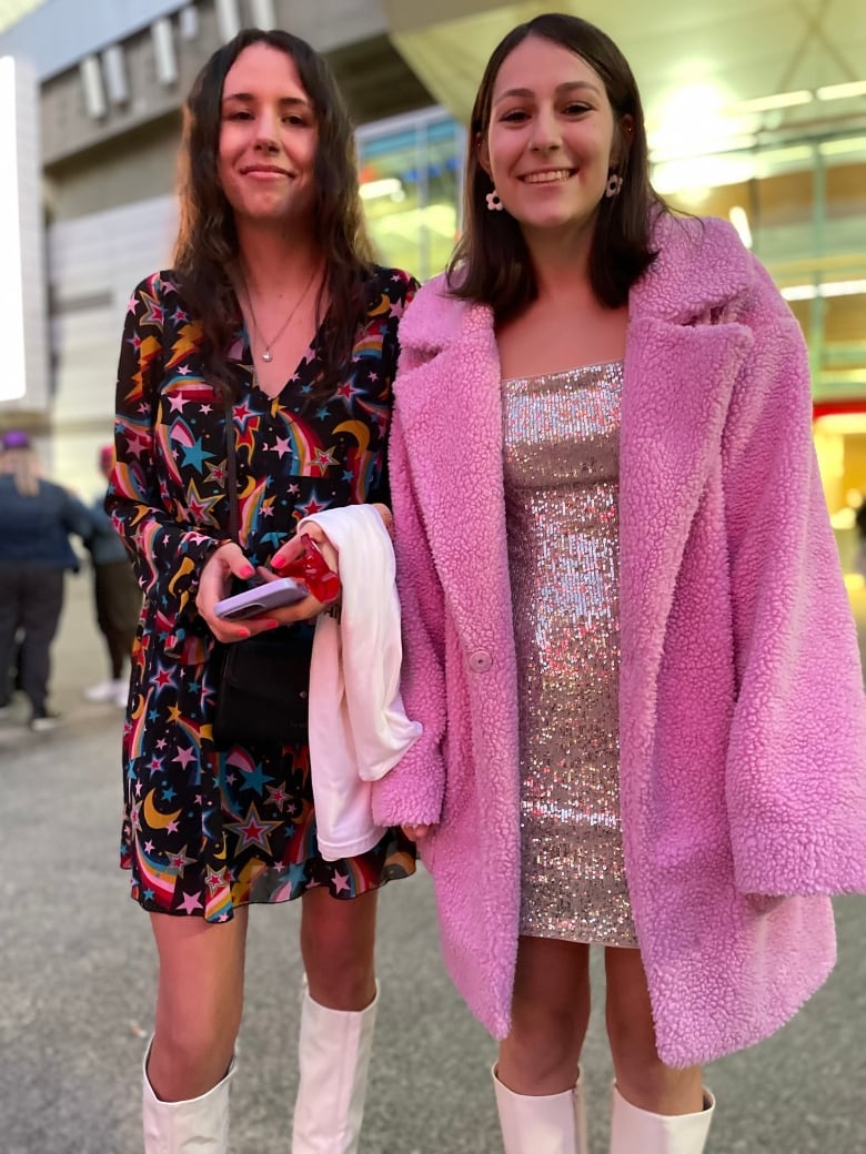 Two young women wearing smart clothes.