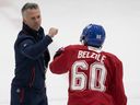 Montreal Canadiens head coach Martin St. Louis pumps his fists with Alex Belzile during the first day of training camp in Brossard on Thursday, September 22, 2022.