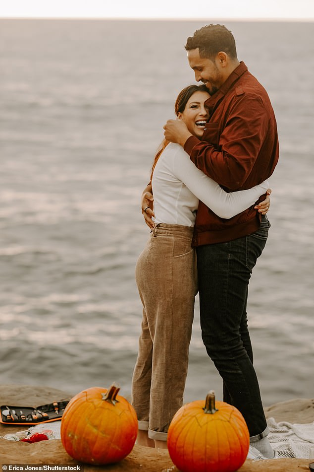 Happiness: The couple cuddled together on the beach