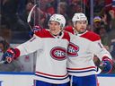 Kaiden Guhle #21 and Josh Anderson #17 of the Montreal Canadiens celebrate an Anderson goal against the Buffalo Sabers during the third period at KeyBank Center on October 27, 2022 in Buffalo, NY