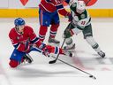 Montreal Canadiens defenseman Arber Xhekaj attempts to lock in the puck against Minnesota Wild center Sam Steel in the third period at the Bell Center on October 25, 2022 in Montreal.