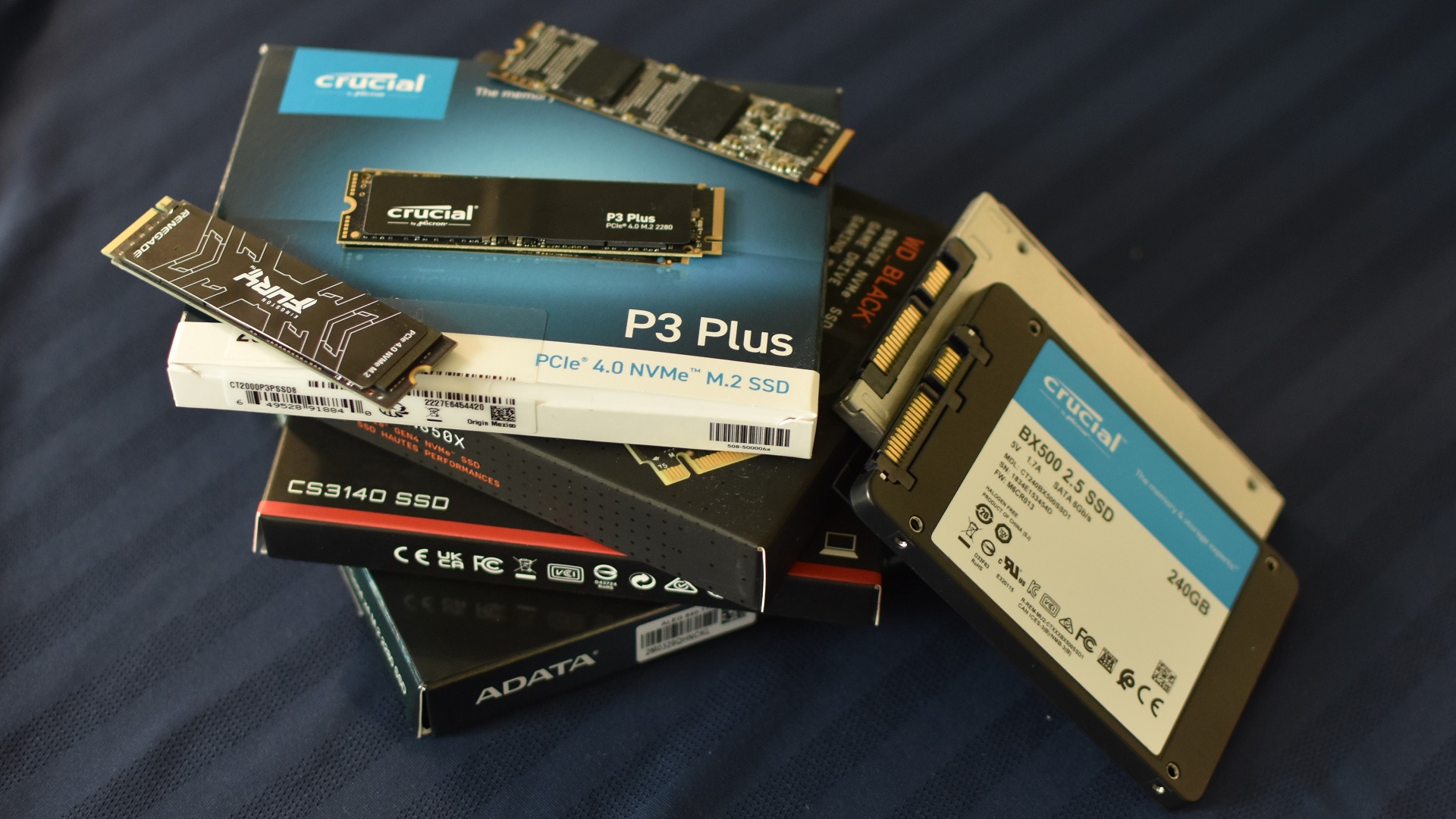 A stack of various NVMe and 2.5 inch SSDs.