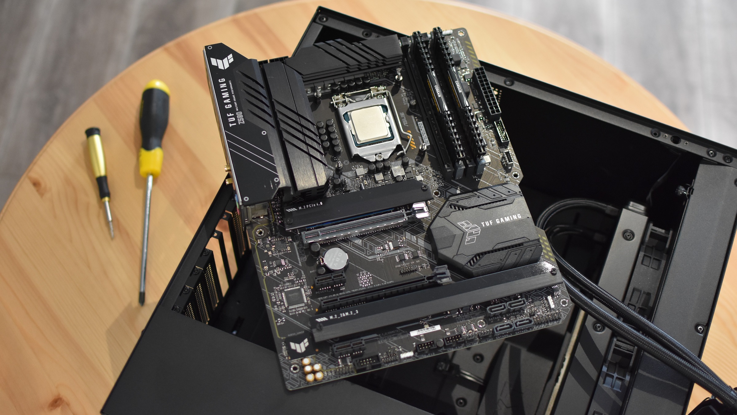 An Asus TUF Gaming Z590-Plus WiFi motherboard on an open PC case.