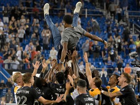 CF Montréal players throw head coach Wilfried Nancy in the air after a 2-2 draw with Columbus Crew in front of a sold-out crowd at Saputo Stadium, which secured the team a place in the MLS playoffs on September 9, 2022.