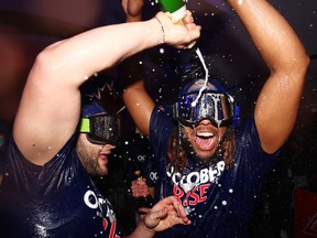 Bo Bichette and Vladimir Guerrero Jr. of the Toronto Blue Jays celebrate their place in the playoffs after defeating the Boston Red Sox on September 30, 2022 at the Rogers Center in Toronto.