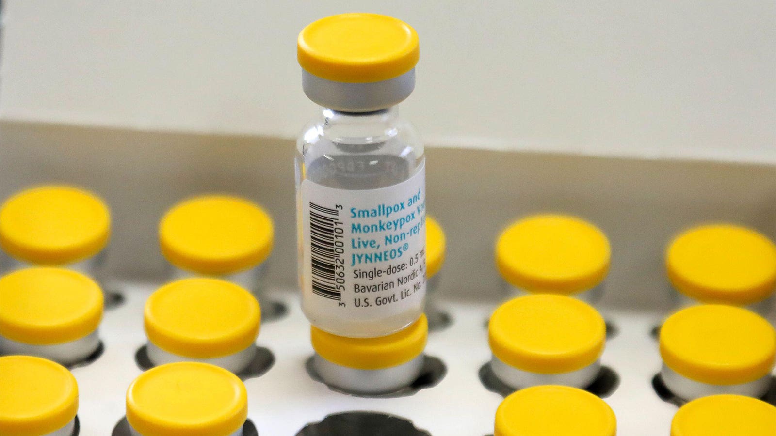 A photo of a vial of Jynneos vaccine sitting atop other vials in a box.