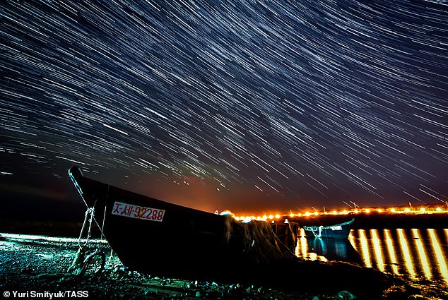 Meteor showers occur when the earth passes through a cloud of cometary debris.  In this case, the draconian meteor shower comes from the debris of Comet 21 P/ Giacobini-Zinner.  Pictured is the night sky over Russky Island during the Draconids