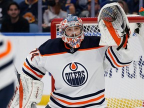 Edmonton Oilers goalie Stuart Skinner (74) keeps an eye on the puck during the first period of an NHL hockey game against the Buffalo Sabers on November 12, 2021 in Buffalo, NY