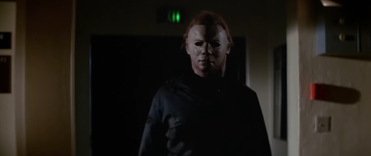 Michael Myers, in his old-school mask but now with redder hair, menaces the camera in Halloween II