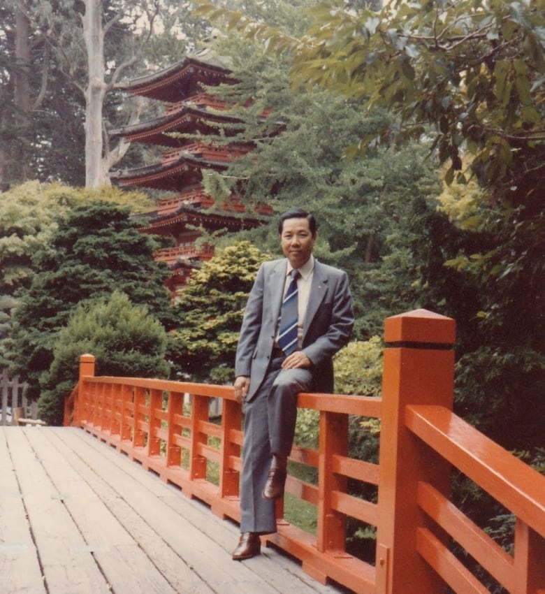 A man in front of a pagoda.