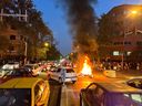 A police motorcycle burns during a protest against the death of Mahsa Amini September 19 in Tehran.