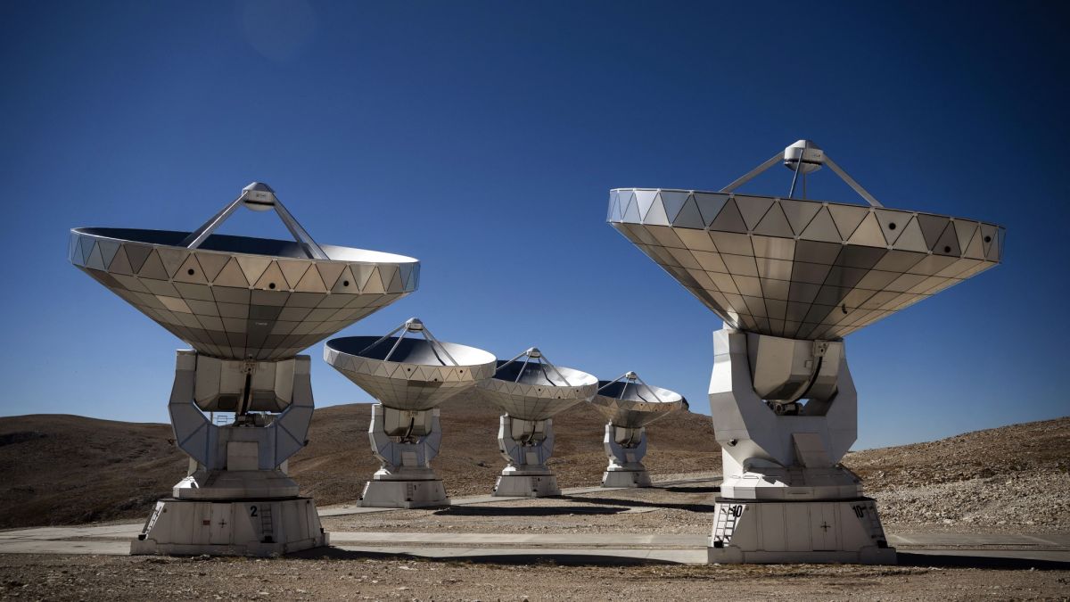 metallic dishes on bases pointed upward to blue sky