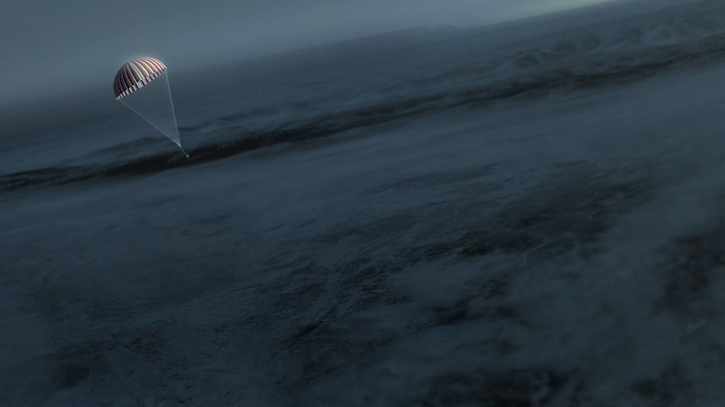 red and white parachute against dark landscape