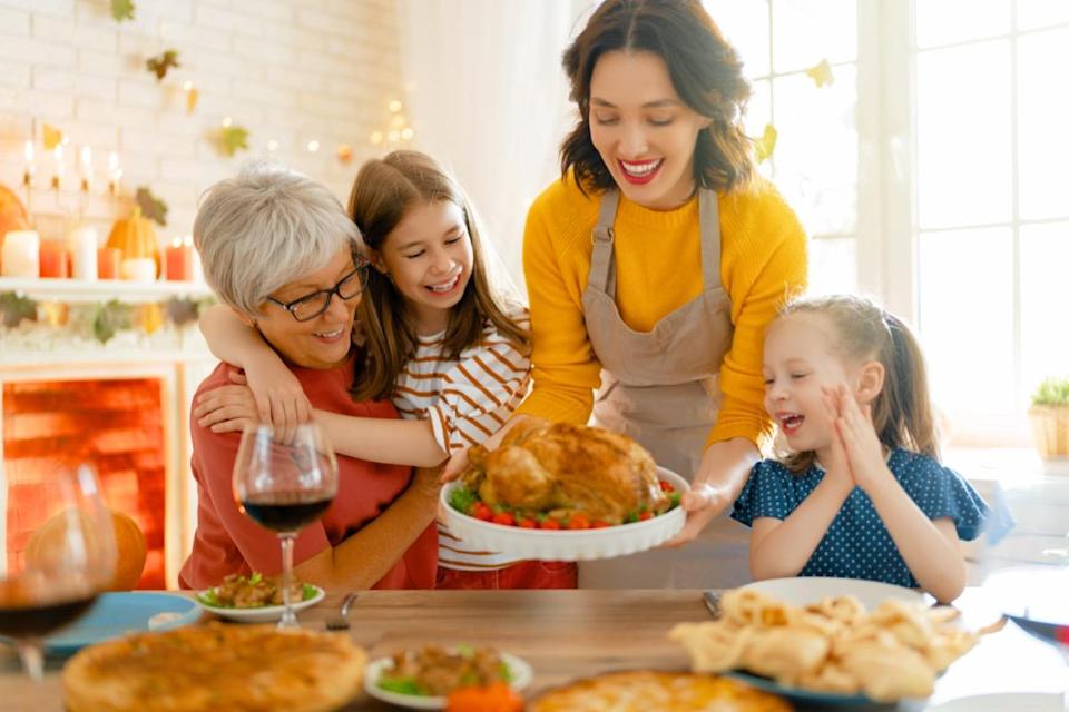 Family sits at the table and celebrates holiday.