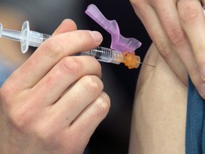 A person receives a flu shot.  (post media)