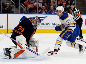 Buffalo Sabers' John-Jason Peterka (77) meets Edmonton Oilers goaltender Stuart Skinner (74) during second NHL action at Rogers Place in Edmonton on Tuesday, October 18, 2022.