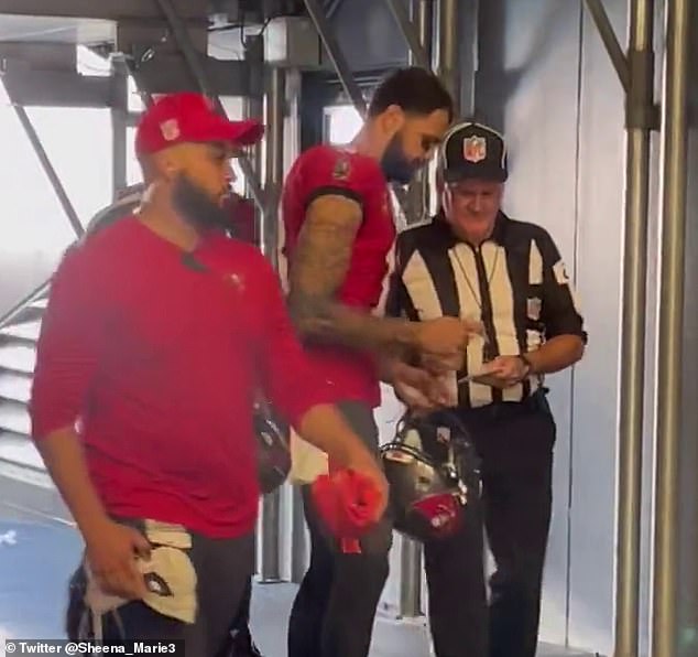 A reporter in the tunnel at Bank of America Stadium in Charlotte spotted officers looking for Mike Evans to sign something for them