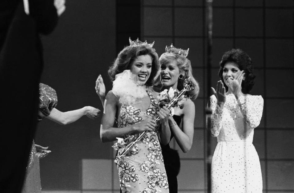 Vanessa Williams, the new Miss America, left, is crowned by outgoing Miss America, Debra Maffett, on September 17, 1983 in Atlantic City, NJ.  (AP photo)