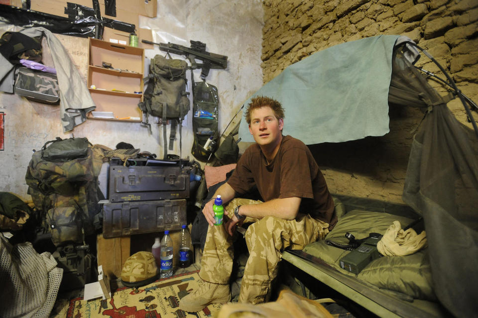 Britain's Prince Harry sits on his camp bed at his accommodation at FOB Delhi (Forward Operating Base) in southern Afghanistan's Helmand province January 2, 2008.  Prince Harry, the youngest son of Prince Charles and the late Princess Diana, has been on the front lines fighting the Taliban in Afghanistan, the Ministry of Defense said in London on Thursday.  The 23-year-old, an officer in the Household Cavalry Regiment, has been secretly serving for the past 10 weeks in the volatile southern province of Helmand, where most British troops are stationed.  AFP PHOTO/John Stillwell/PA POOL (Photo by JOHN STILLWELL/POOL/AFP) (Photo by JOHN STILLWELL/POOL/AFP via Getty Images)