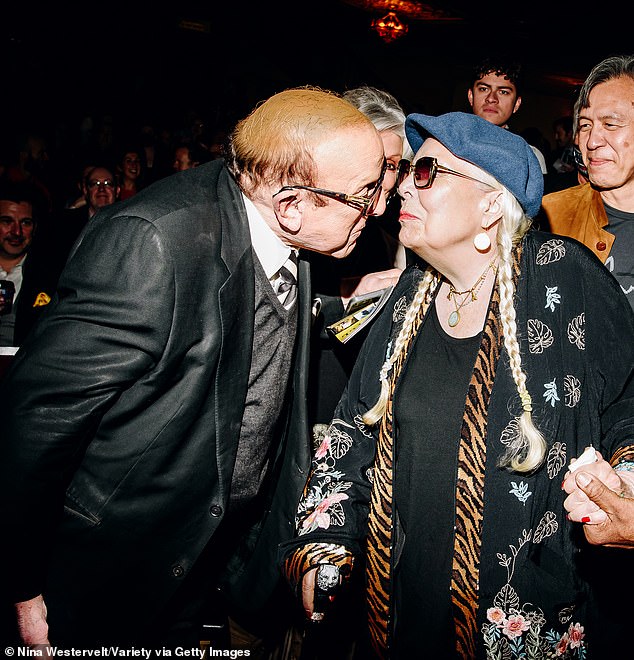 Long time no see!  music mogul Clive Davis, 90;  was seen leaning in for a kiss to greet Joni (born Roberta Joan) in time before the curtain rose